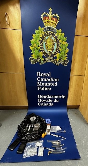 A number of items are displayed, including quantities of cocaine and suspected heroin and various drug paraphernalia, on a banner that reads Royal Canadian Mounted Police, Gendarmerie Royale du Canada.